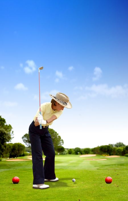 female golfer playing on a golf course on a sunny day