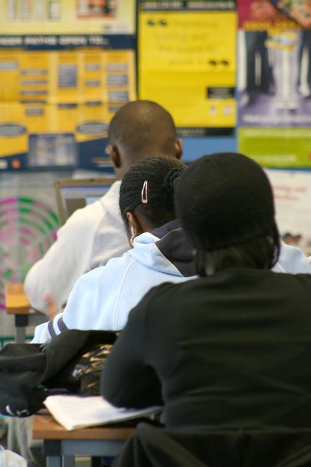 three teenagers working in a library