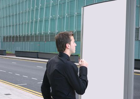 business man looking at a white panel