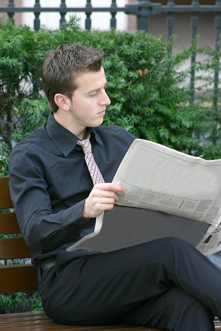 business man reading a newspaper during his lunch break