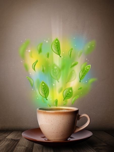 Tea cup with leaves and colorful abstract lights, close up