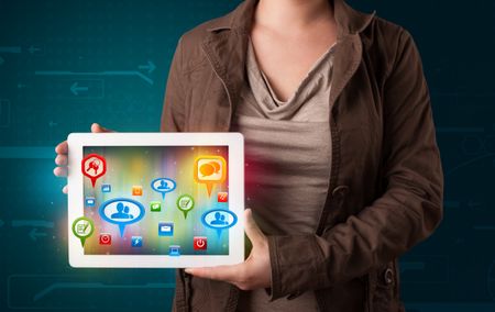 Young girl presenting a tablet with colorful social icons and signs