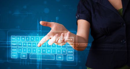Young girl pressing virtual type of keyboard