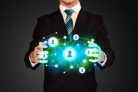 Businessman holding social media network icons structure