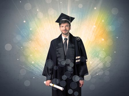 Happy graduate with colorful bokeg lights in the background grunge wall