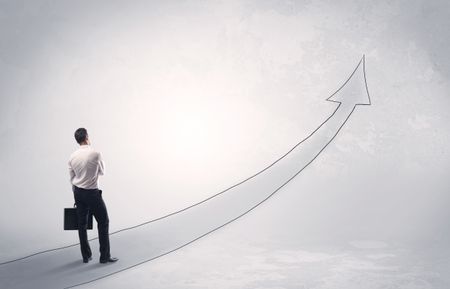 Adult elegant male with briefcase standing on drawn grey arrow pointing up financial concept