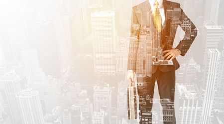 Business man with warm color overlay of city background texture
