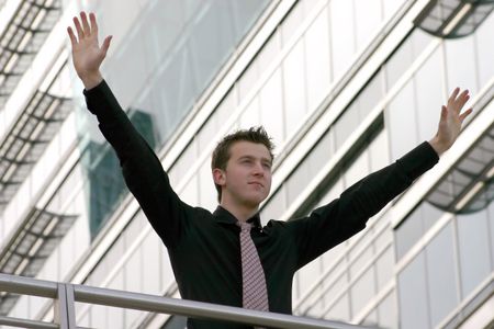 business man with arms up symbolizing victory