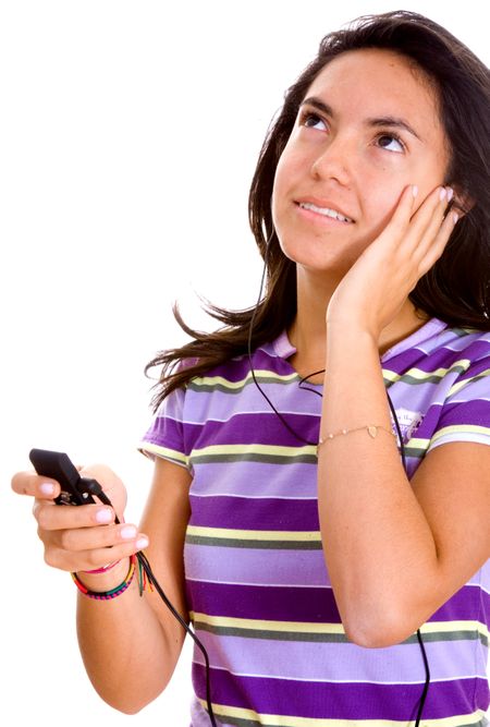teenager listening to music on an mp3 player - isolated over a white background