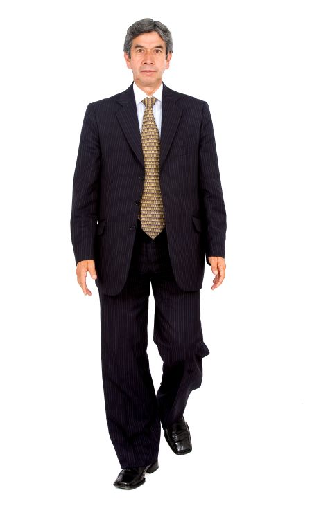 Business man walking towards the camera - isolated on white