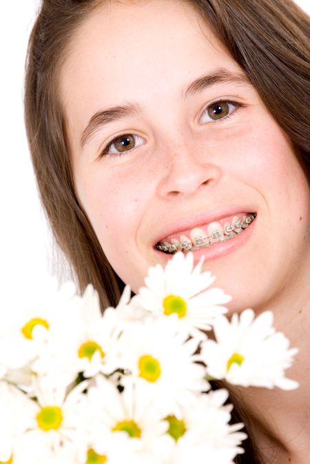 beautiful girl with flowers smiling using braces