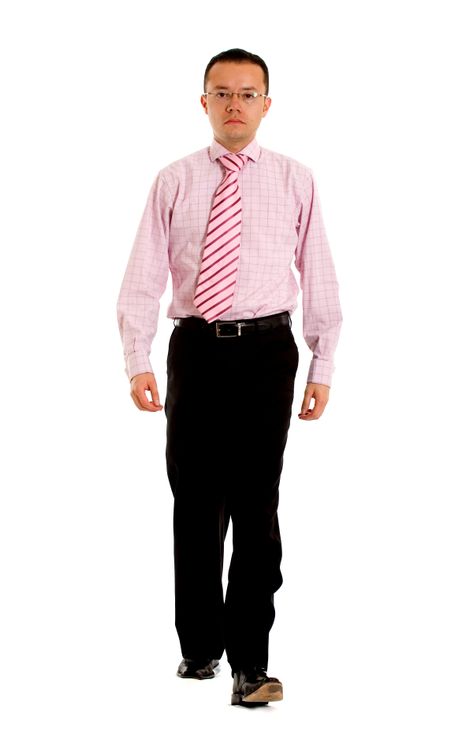 Business man walking towards the camera - isolated over a white background