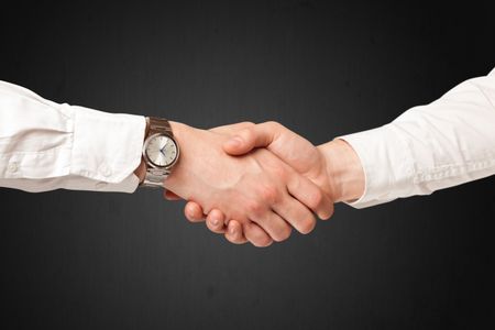 Business handshake on black background