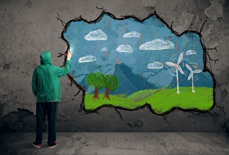 Young urban painter drawing colorful future image on the wall