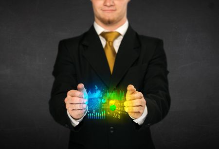 Businessman holding a shining diagram cloud in front of his body

