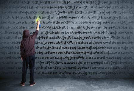 young-urban-painter-drawing-random-letters-350940590 Young urban painter drawing random letters on the wall