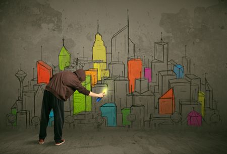 Young urban painter drawing colorful city  on the wall