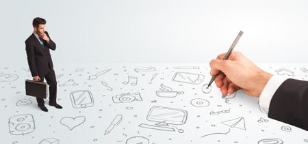 businessman-looking-hand-drawn-icons-symbols-350949410 Little businessman looking at hand drawn icons and symbols concept on background