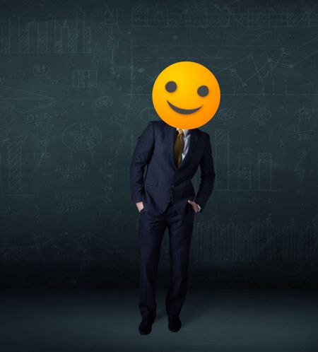 Funny businessman wears yellow smiley face