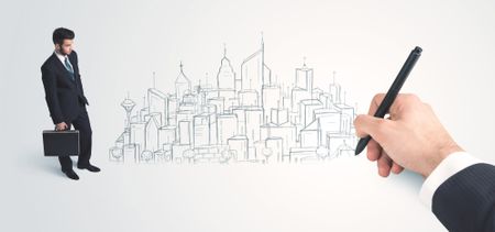 Businessman looking at hand drawn city on wall concept on background