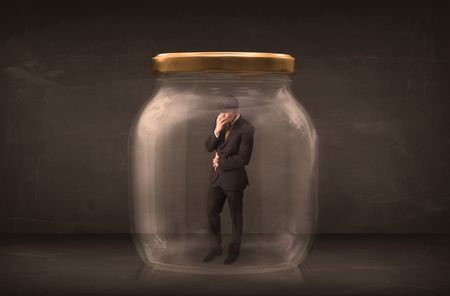 Businessman shut into a glass jar concept on background