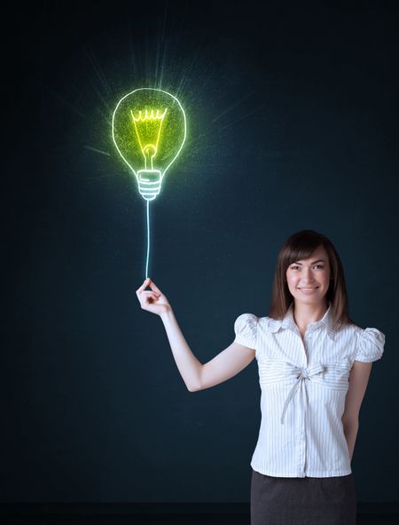 Businesswoman hold a shining idea bulb on a blue background