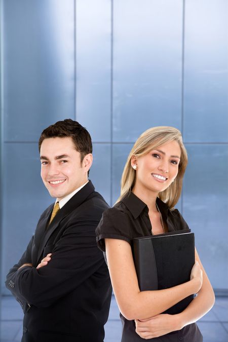 Couple of business people smiling with blue background