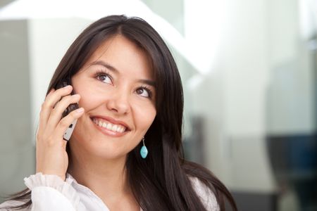 Business woman talking on the phone smiling