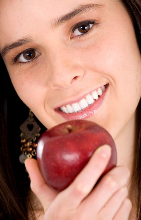 portrait of a girl holding an apple smiling