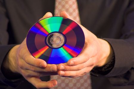 business hands holding a CD