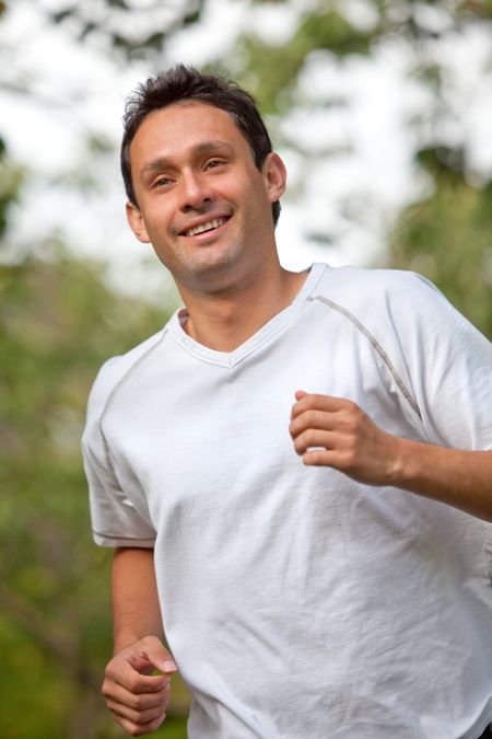 Handsome athletic man jogging at a park