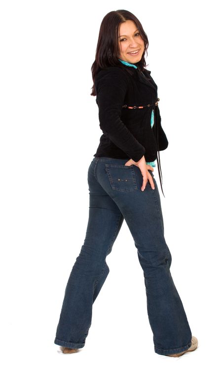 casual girl standing from the back facing the camera - isolated over a white background