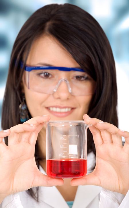 female scientist in a laboratory holding a test tube with red liquid