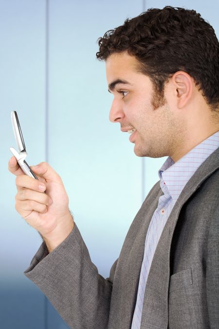 Business man on the phone smiling in an office environment