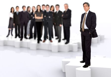 business leadership and teamwork with a businessman in front of a businessteam all standing on puzzle pieces
