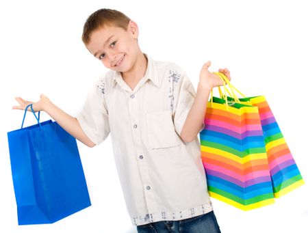 child with shopping bags smiling - isolated over a white background