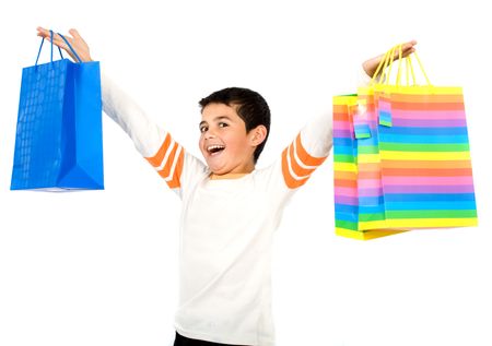child with shopping bags smiling - isolated over a white background