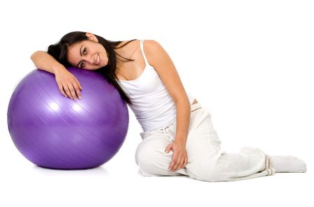 girl in white with a purple pilates ball