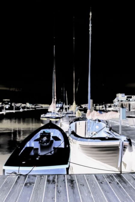 Nocturnal illustration of boats tied up in a coastal marina in the Pacific Northwest, with diffuse glow effect, for motifs of lifestyle or travel