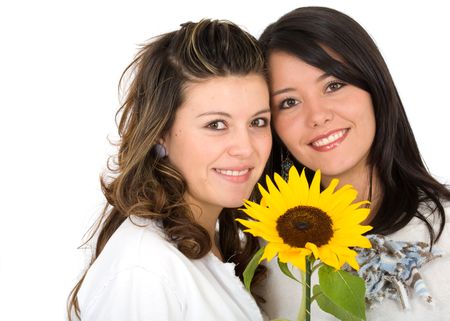 beautiful sisters portrait with a yellow sunflower - isolated over a white background