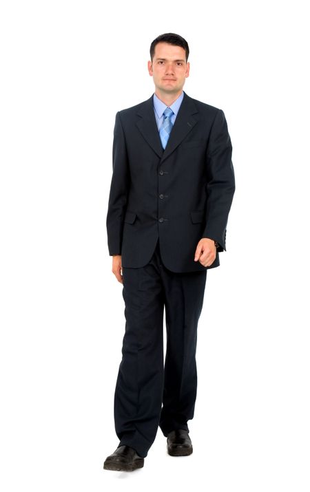 Business man walking towards the camera - isolated over a white background