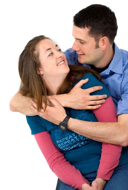 young couple smiling and looking at each other - isolated over a white background