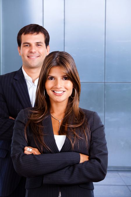 Business couple portrait smiling at an office