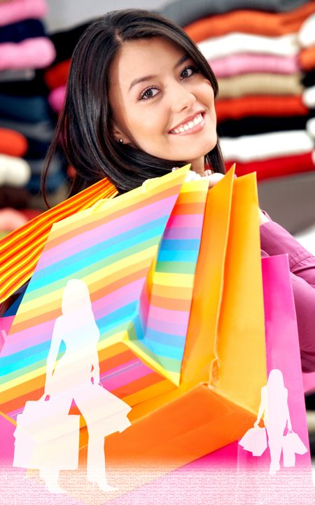 girl in a retail store smiling and carrying shopping bags