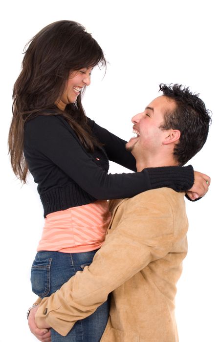 young couple smiling and standing facing each other - isolated over a white background