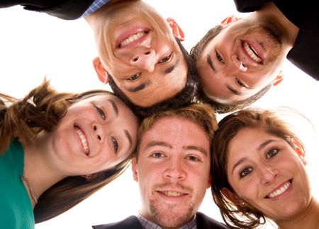 business team with their heads together over a white background