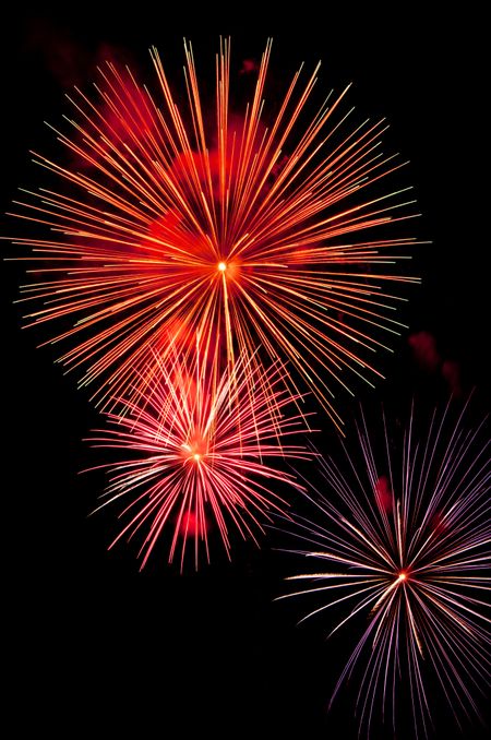 Elegant bursts of fireworks with streaks in similar patterns but different colors