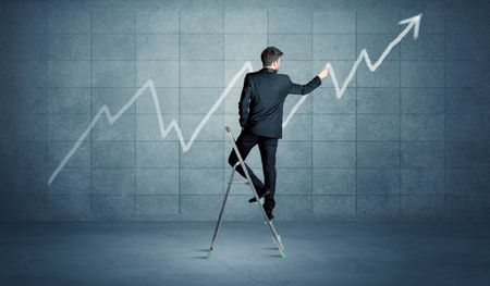 A man standing on a ladder and drawing a chart on blue wall background with exponential progressing curve, line