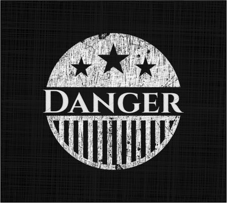 Danger chalkboard emblem written on a blackboard