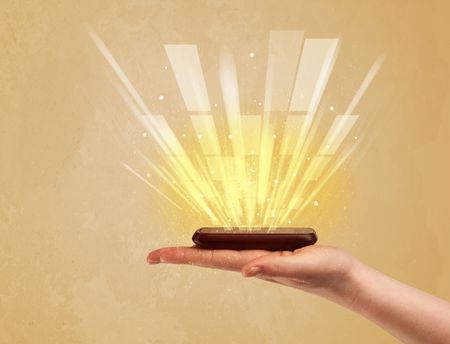 A caucasian hand holding a tablet phone with light beams and information escaping the device illustration concept
